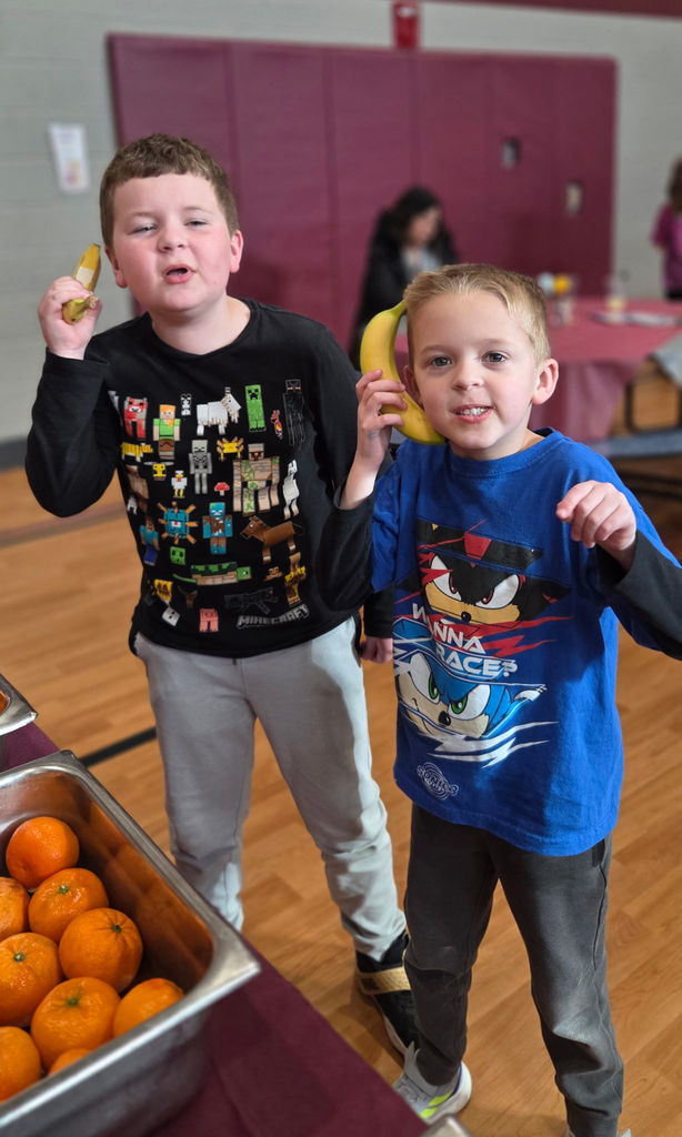 Students pretending to talk on a banana telephone.