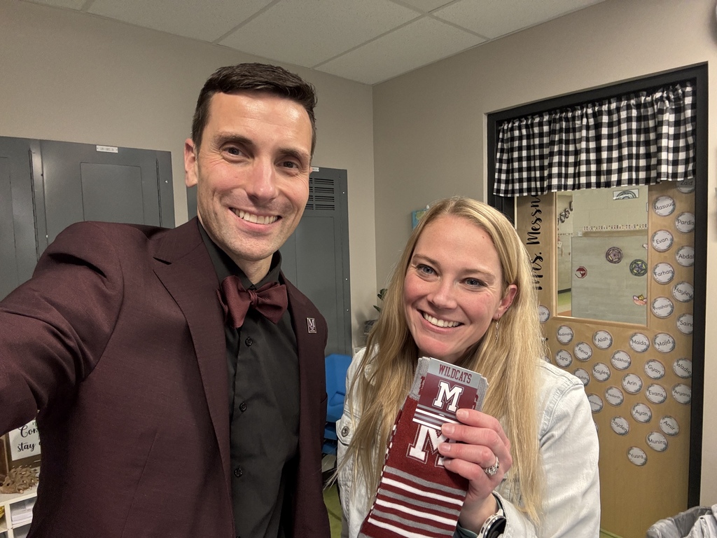A man standing next to a woman with a pair of branded socks.