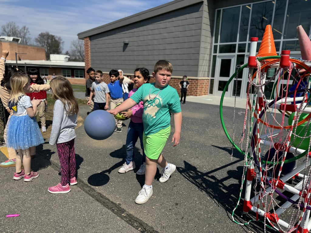 Young students walking to a school playground for recess.