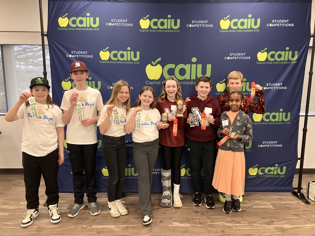 A group of students showing off their ribbons.