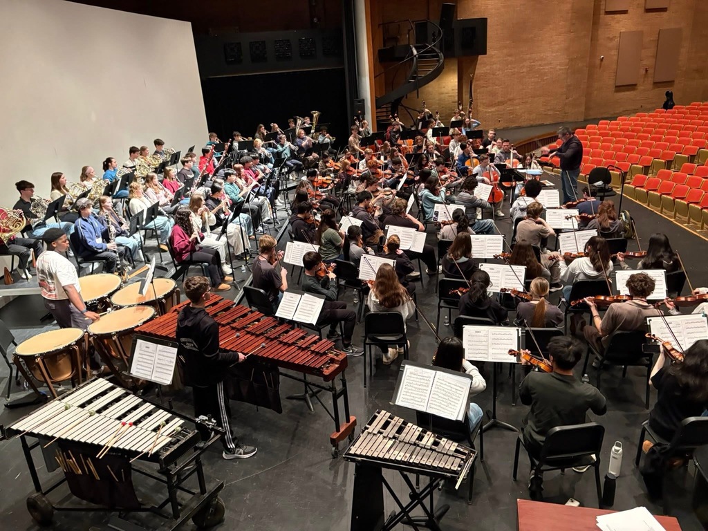 Student musicians come together on stage.