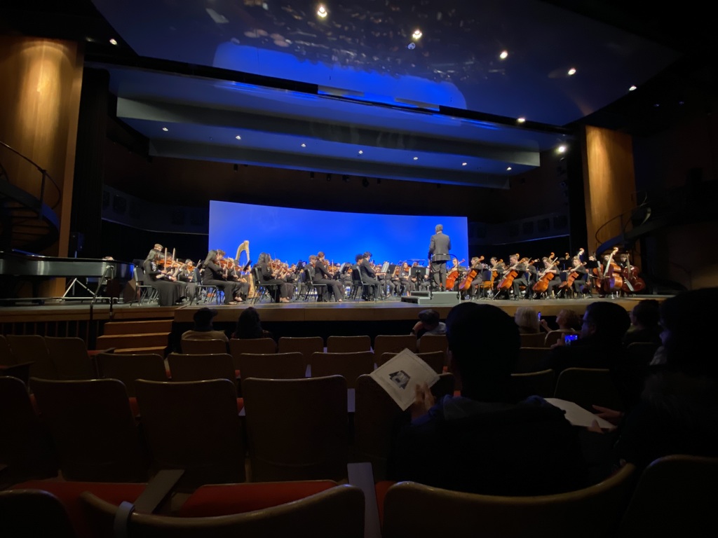 Student musicians come together on stage.