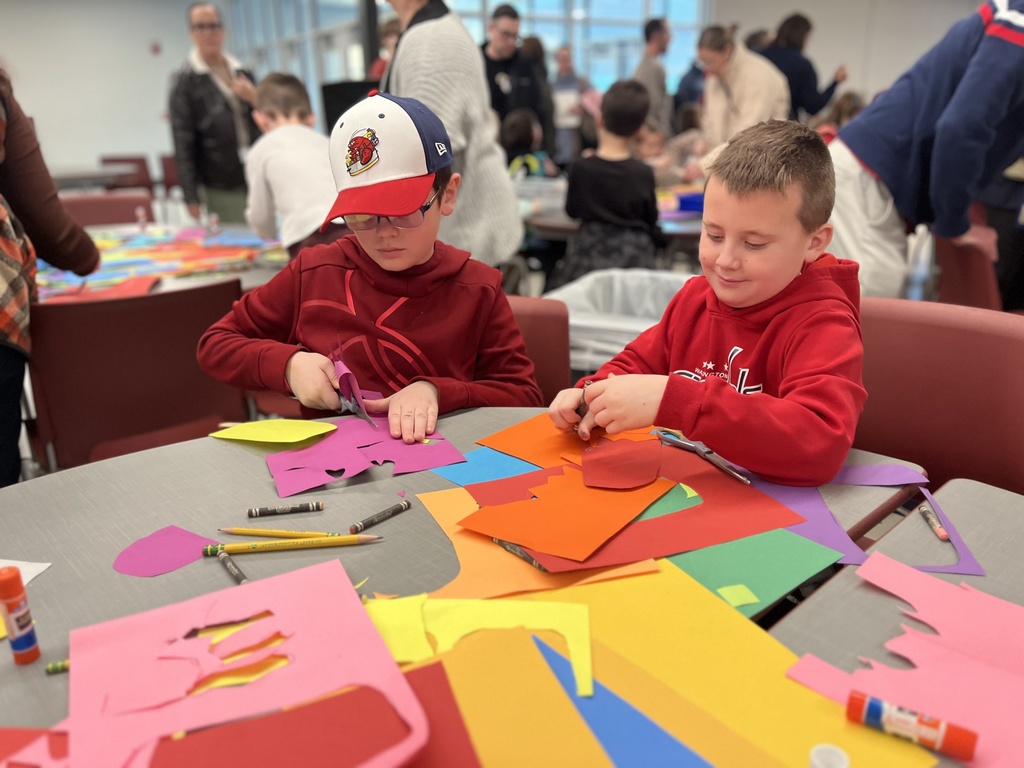 Students at a table creating colorful art.