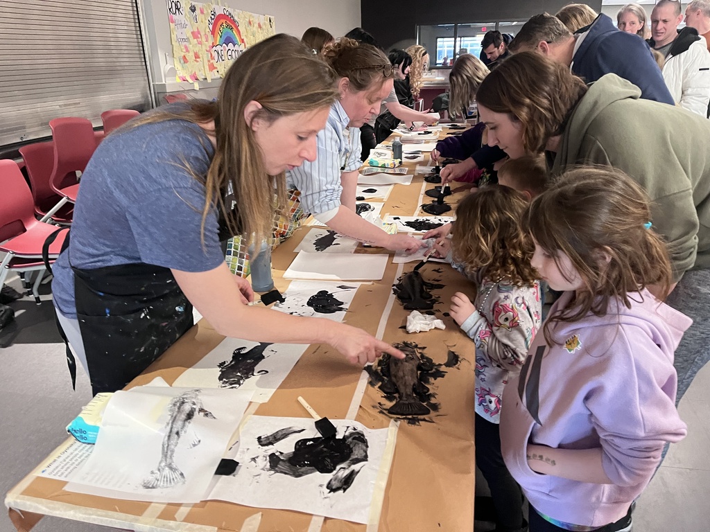 Students at a table creating  art.