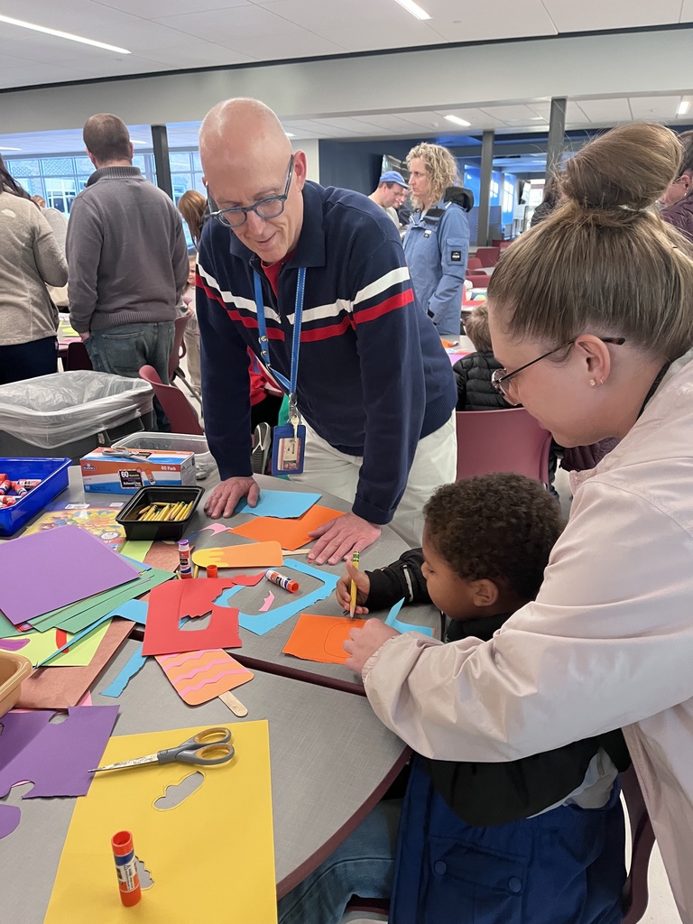 Students at a table creating colorful art.