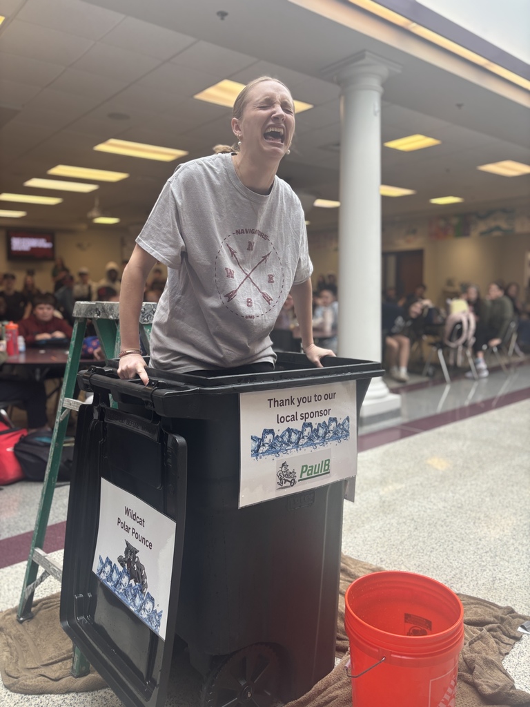 A woman making a shocked face while plunging into ice cold water.