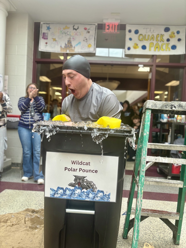 A man making a shocked face while plunging into ice cold water.