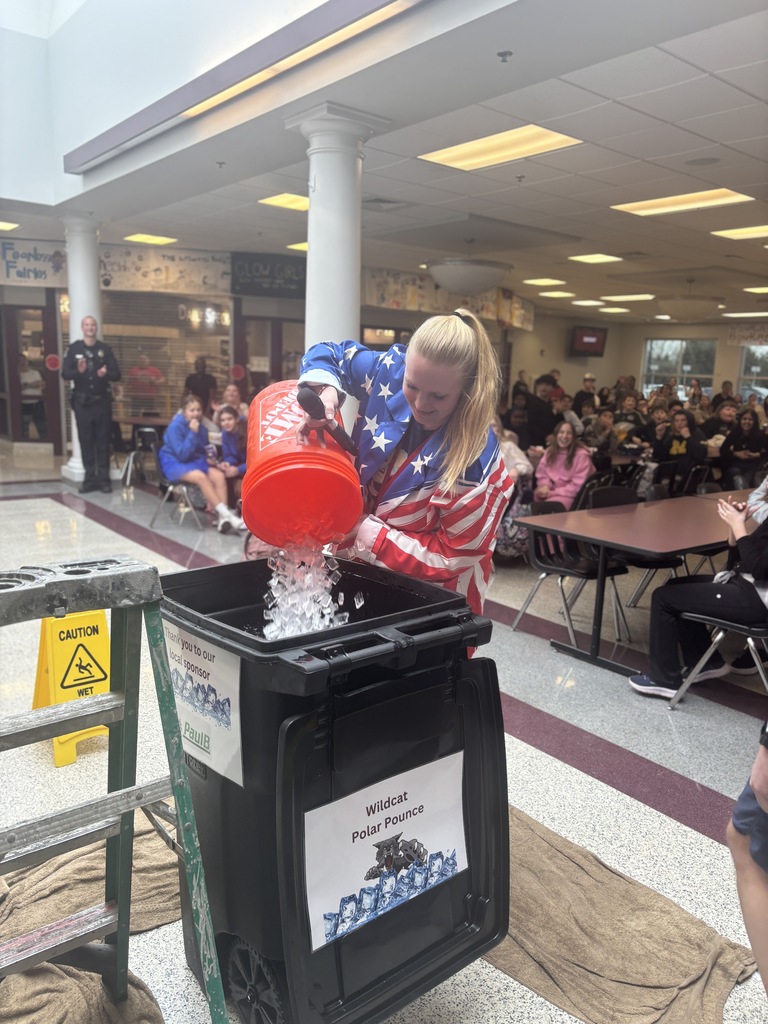 A teacher dumps a bucket of ice into cold water.
