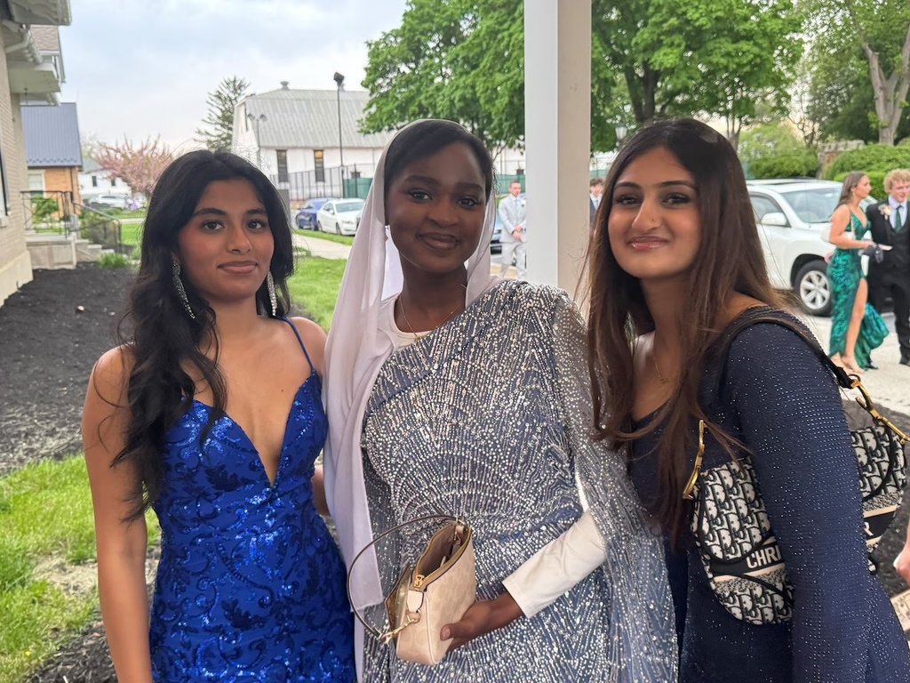 Three young ladies dressed up for Prom.