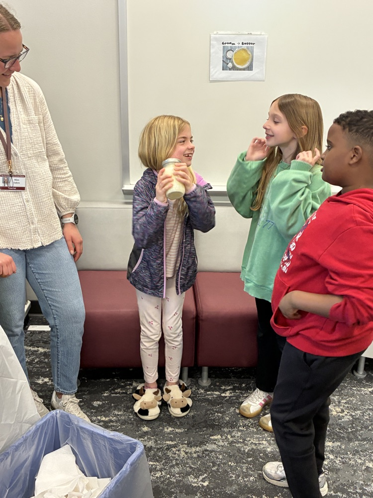 Students shaking a jar of cream to make homemade butter.