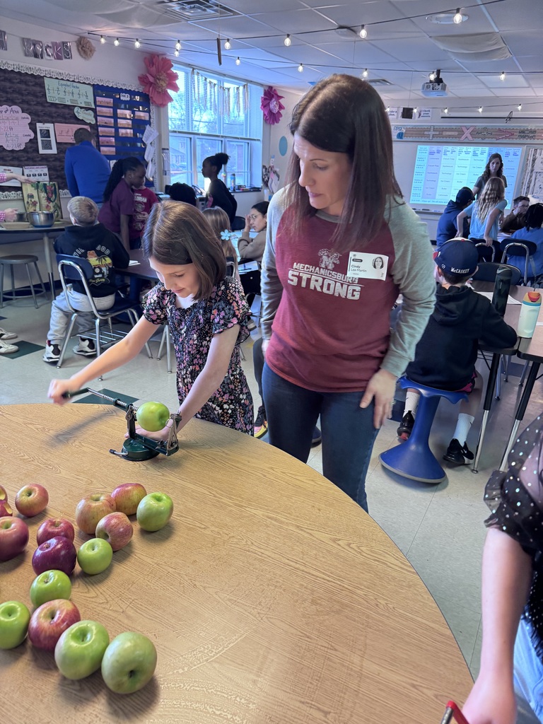 A student peels and cores an apple.