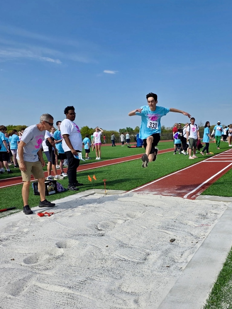 An athlete jumps into the air as part of the long jump in track and field.