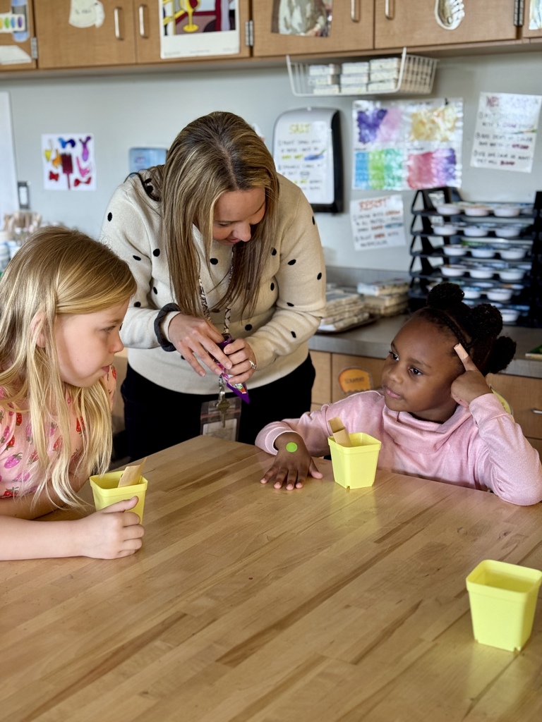 Two young students talk to an adult about something they love about themselves.