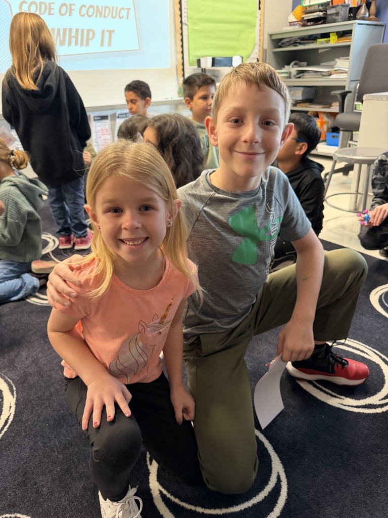 Two young students smiling for a photo.