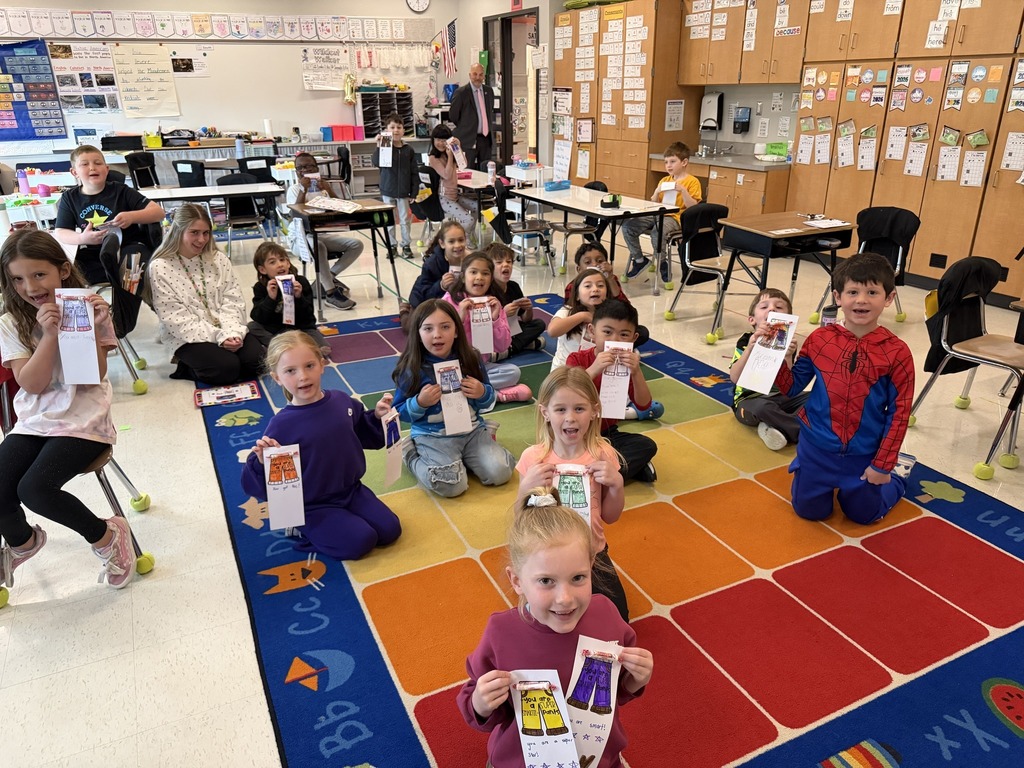 Students showing off notes that they colored and wrote.