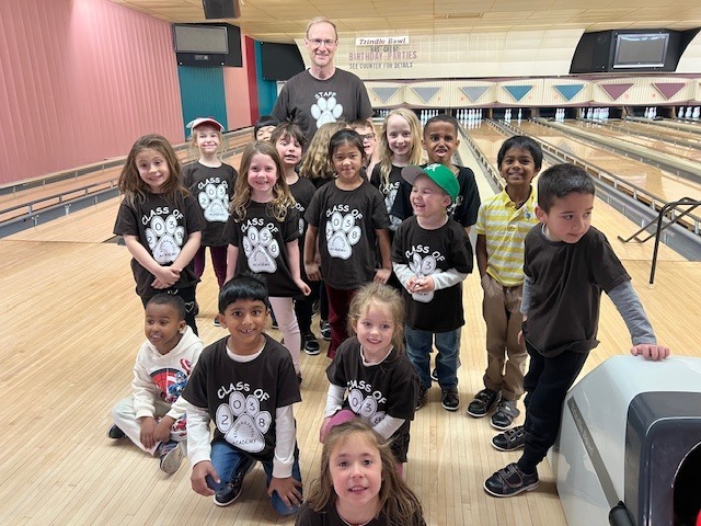 A group of young students at a bowling alley.