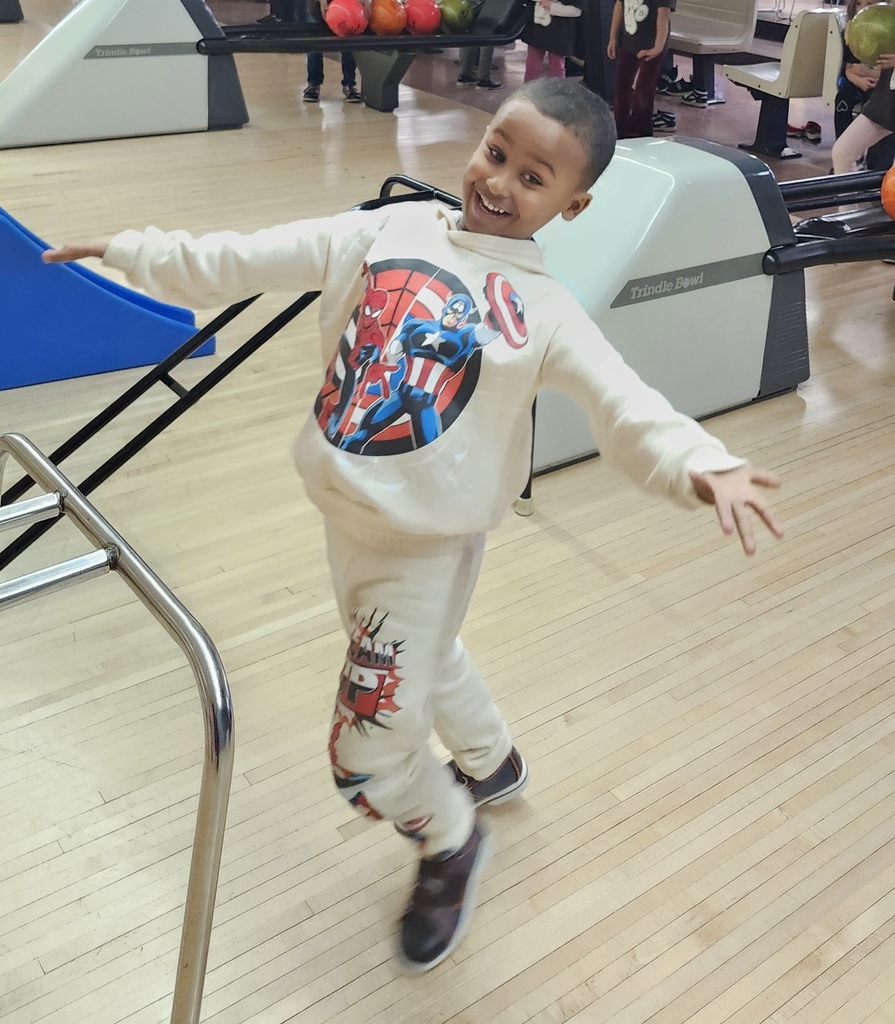 A boy cheering after he bowls a ball.