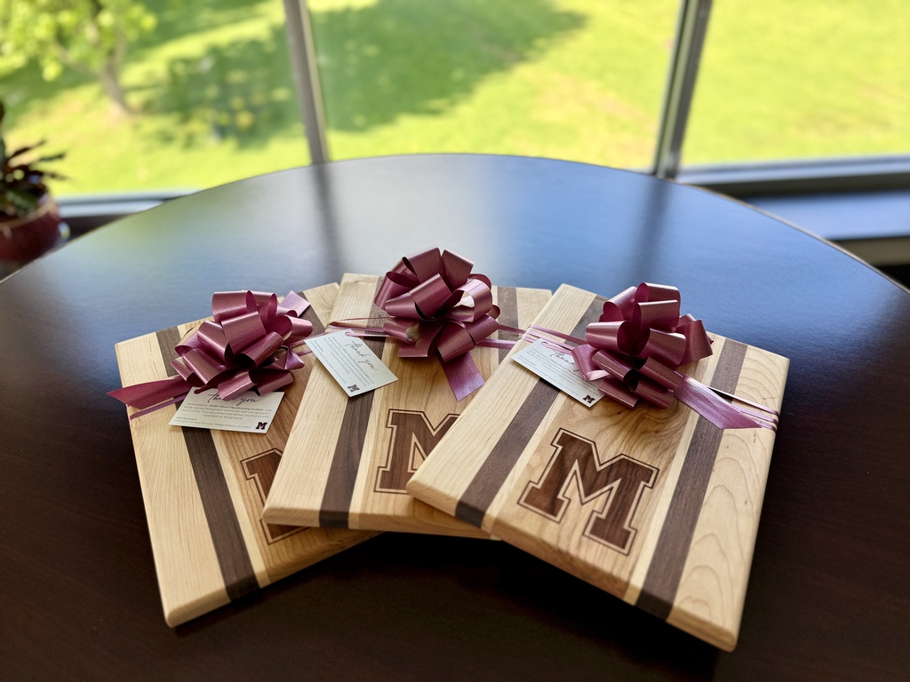 Three handcrafted cutting boards sitting on a table.