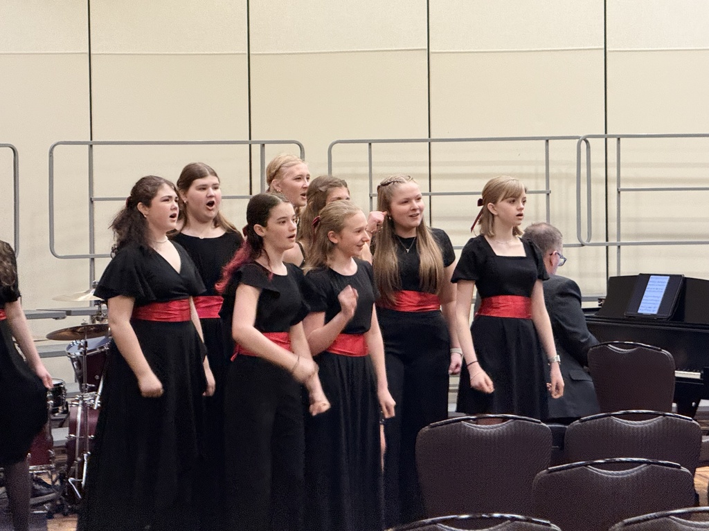 A group of student musicians performing on a stage.