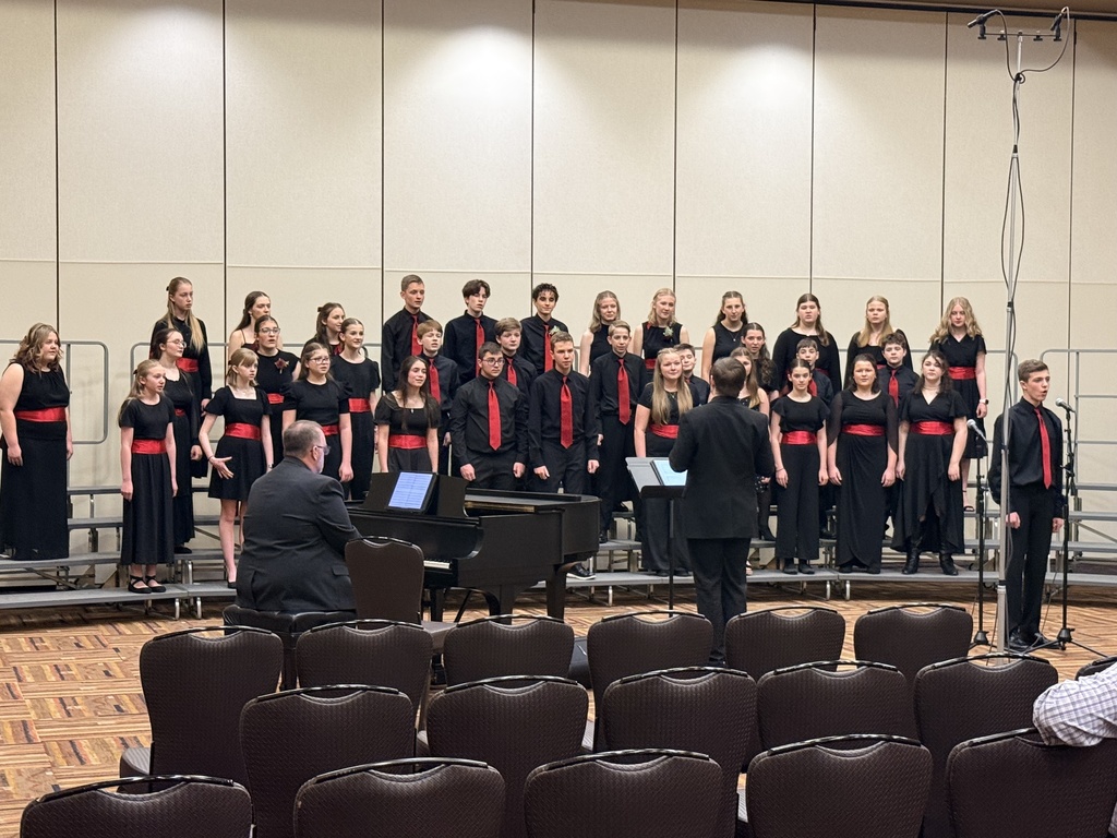 A group of student musicians performing on a stage.