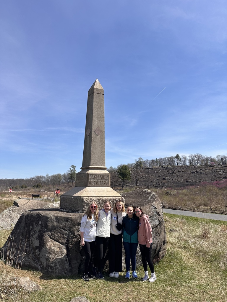 Students stand in front of a monument at Gettysburg National Military Park.
