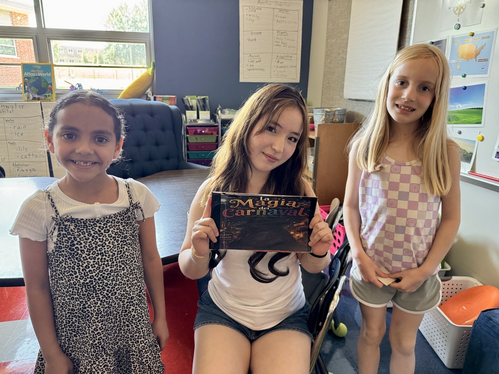 A high school student reads to elementary students.