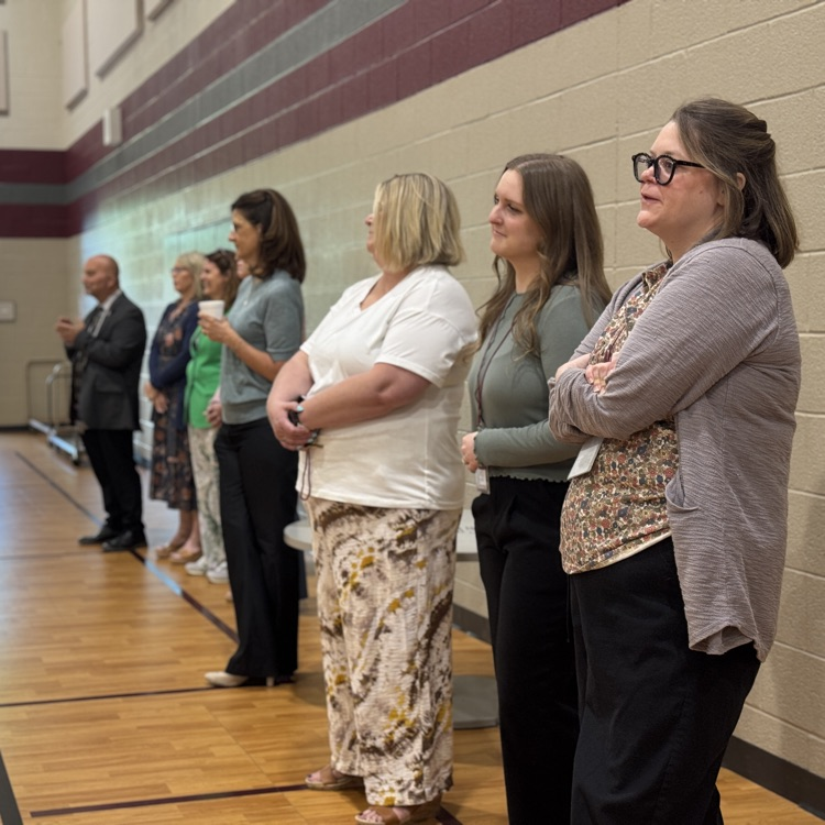 adults clap as students finish a concert