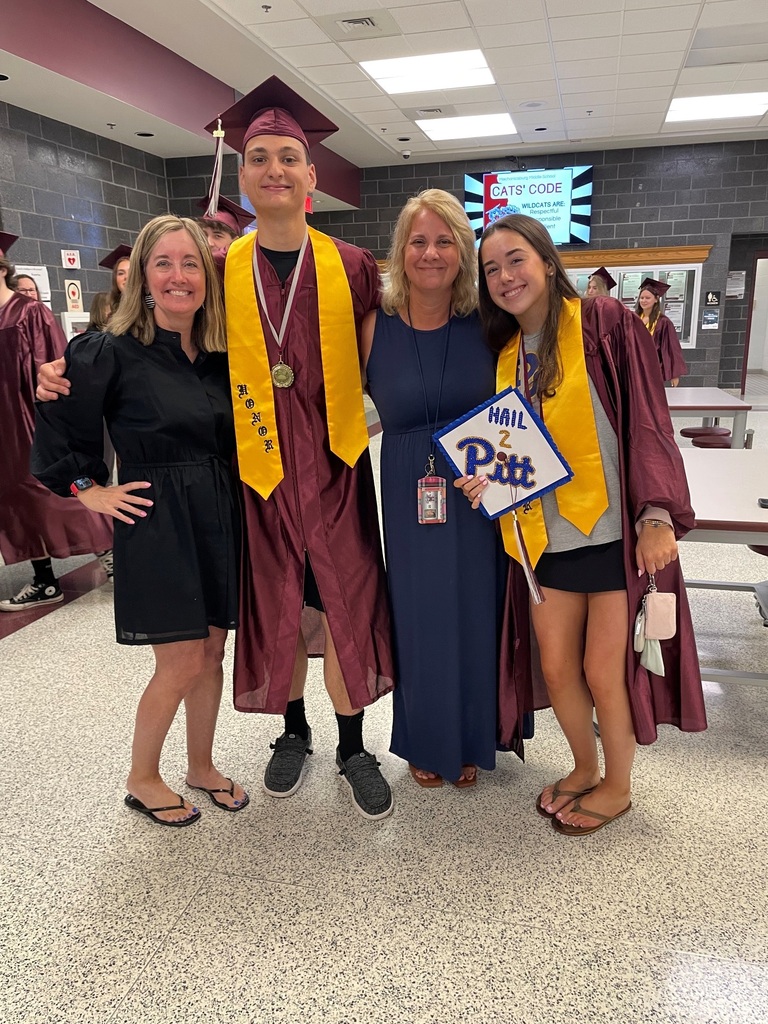 Two proud moms with their graduates.