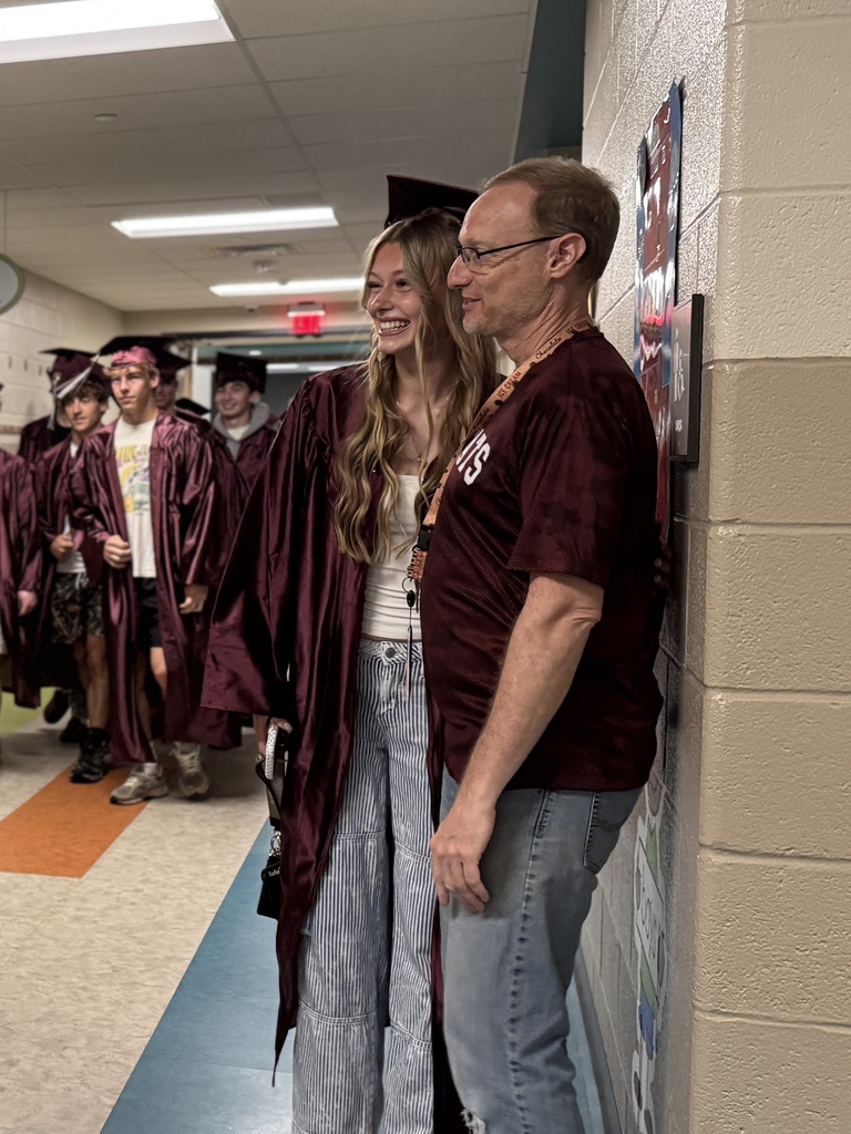 A graduate with a former teacher.
