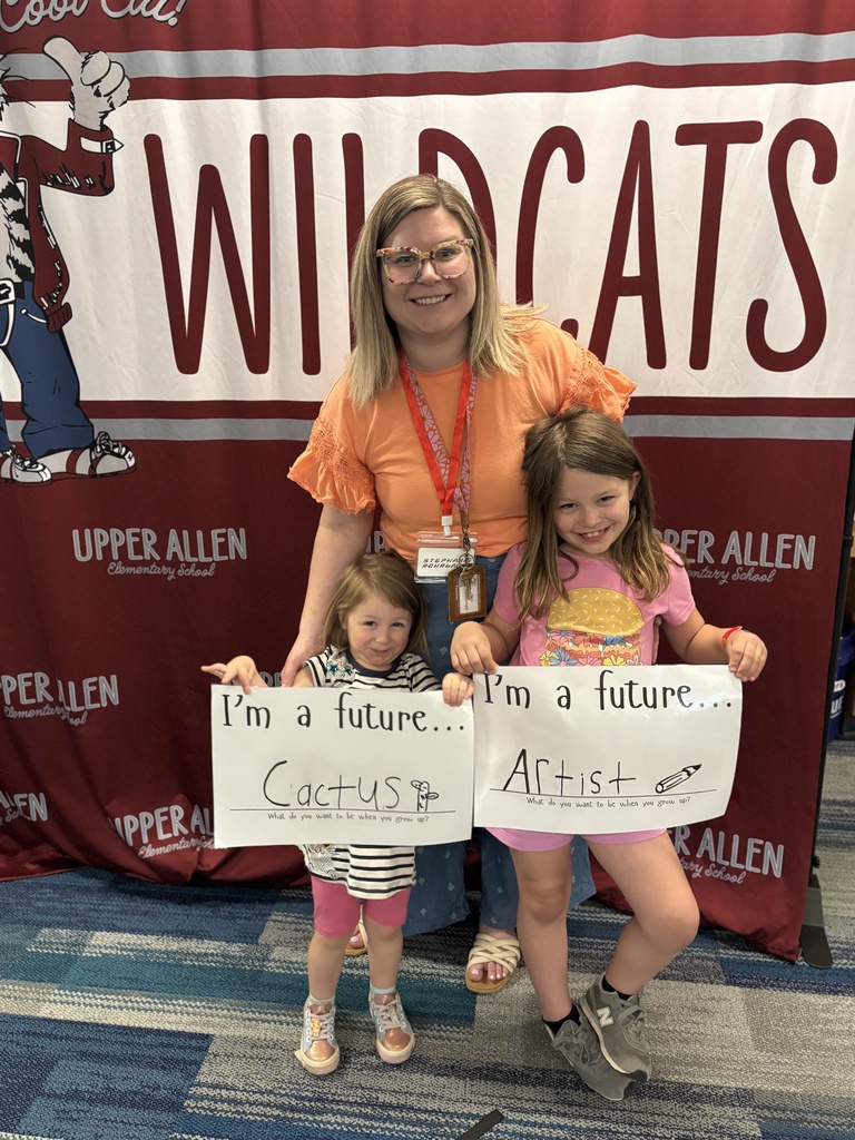 two young students holding a sign that says I'm a future cactus and future artist.