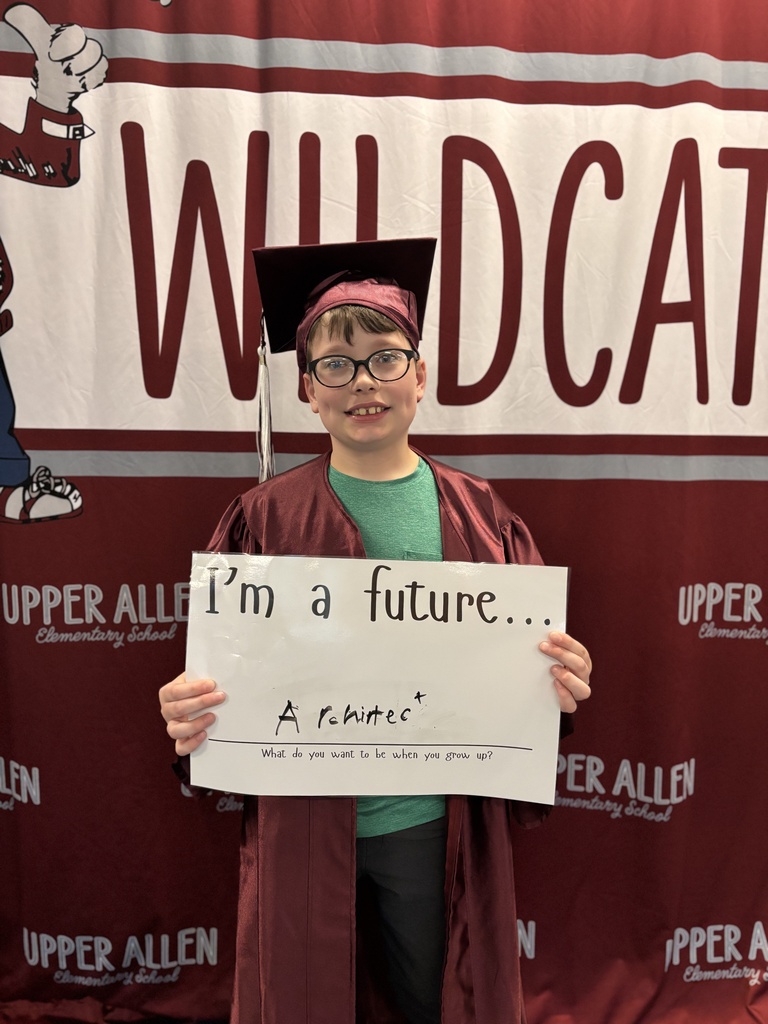 Young student wearing a cap and gown and holding a sign that says I'm a future architect.
