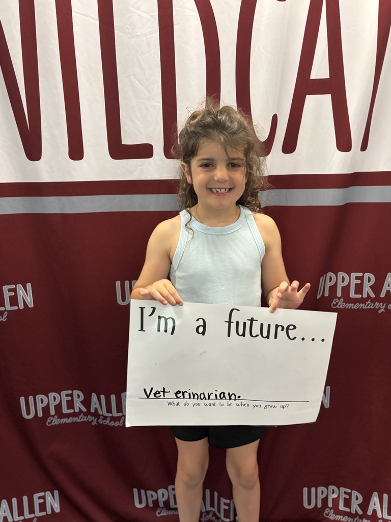 Young student holding a sign that says I'm a future veterinarian.