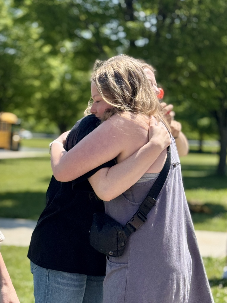 A teacher hugs a student goodbye on the last day of school.