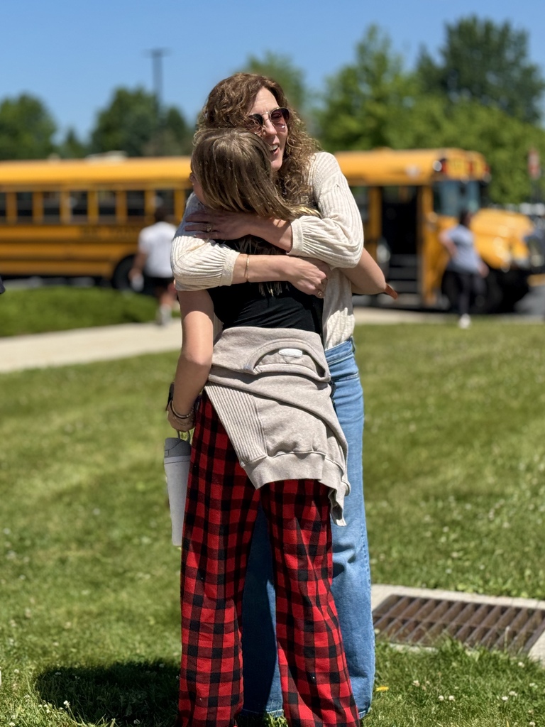 A teacher hugs a student goodbye on the last day of school.