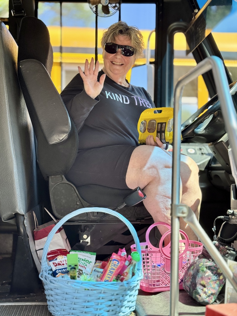A bus driver waving goodbye.