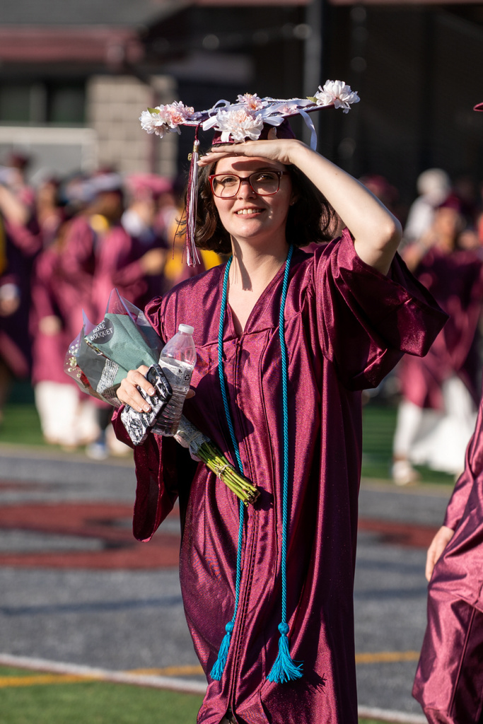 A graduate scans the crowd looking for her supporters.