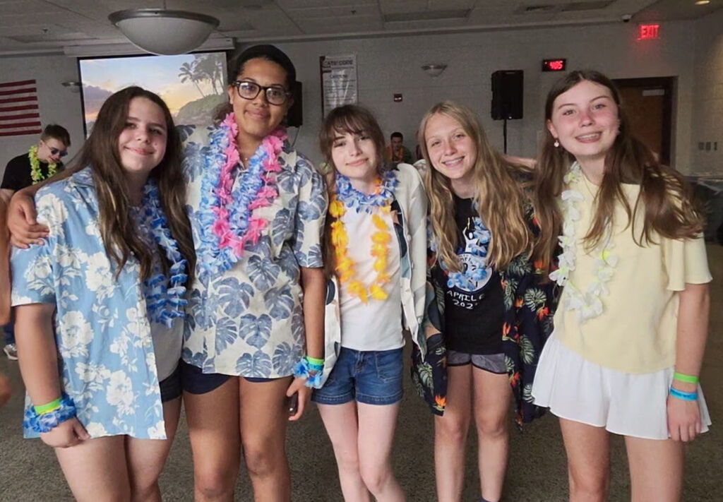 Students wear hawaiian shirts and leis.