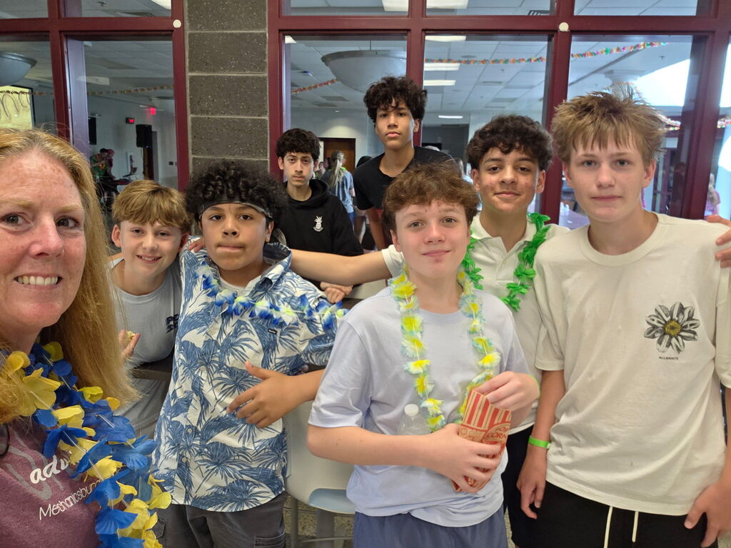 Students wear hawaiian shirts and leis.