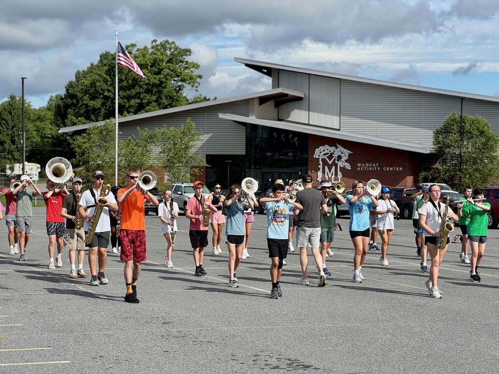 Students hold instruments and practice marching.