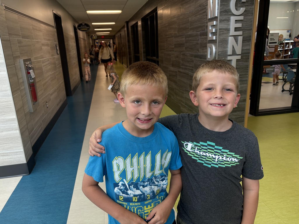 Students standing in a school hallway.