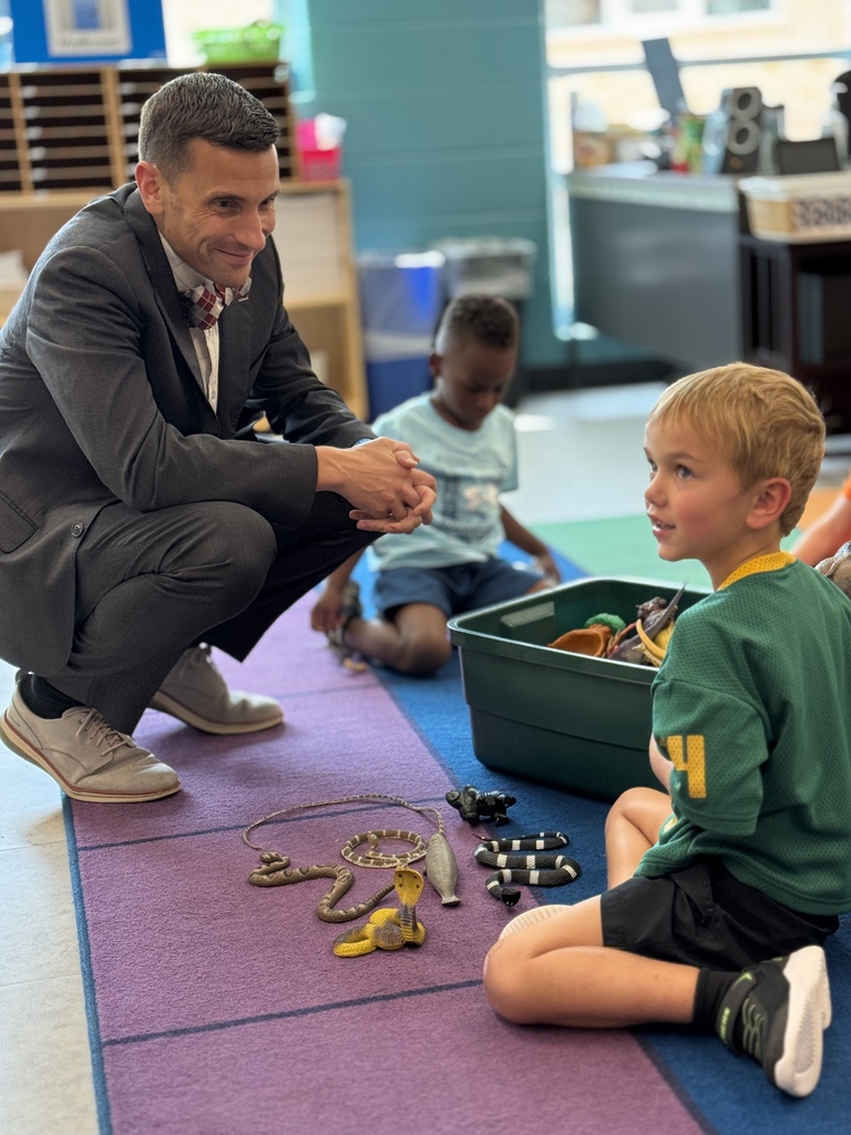 A man talks about animals with a little student.