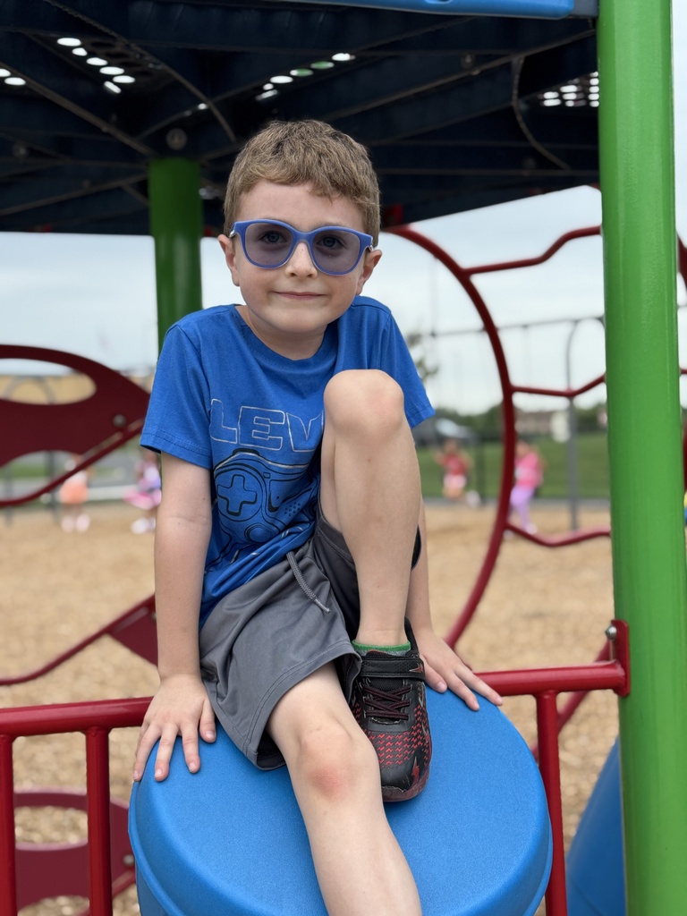 A boy sits on the school playground
