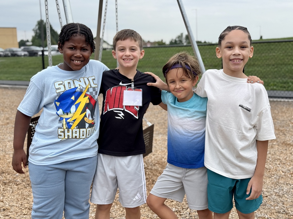 Four friends on a school playground.