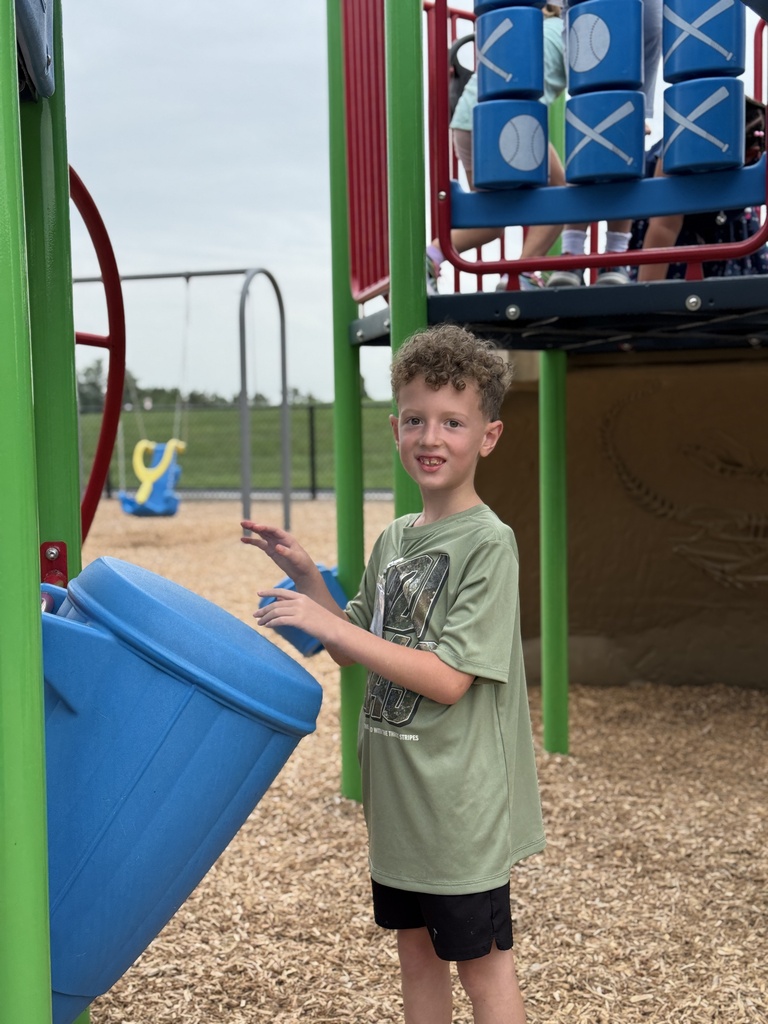 A boy plays drums on the playground.