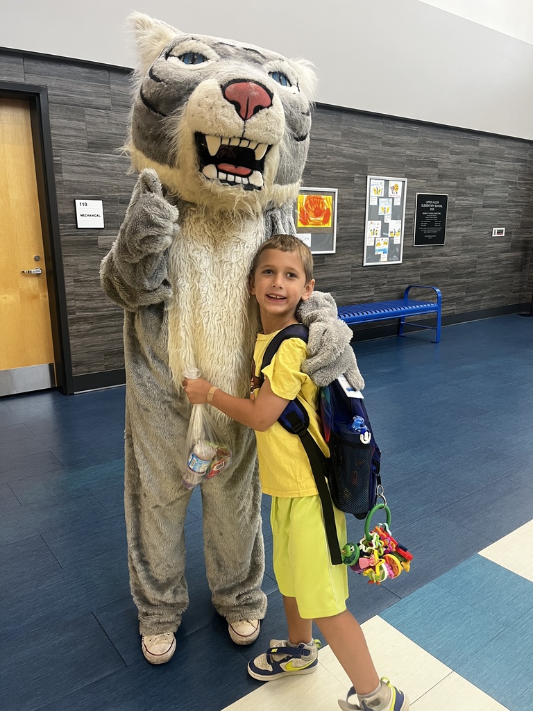 Wildcat mascot greeting students.