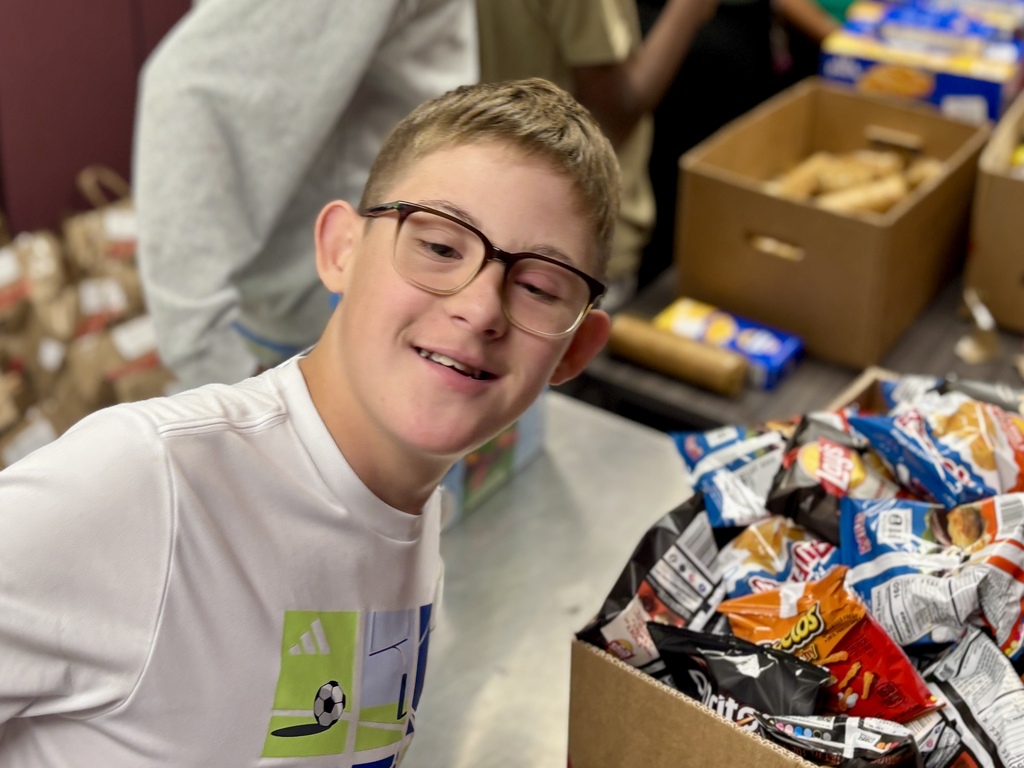 Students pack food bags.