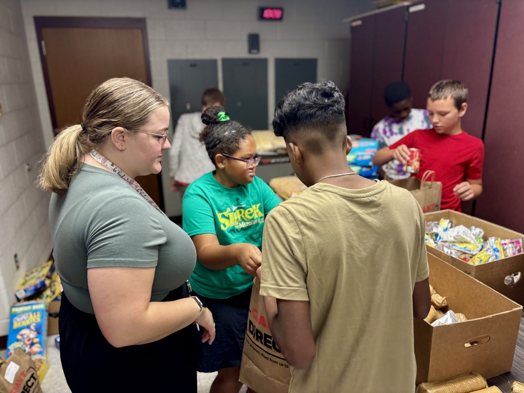 Students pack food bags.