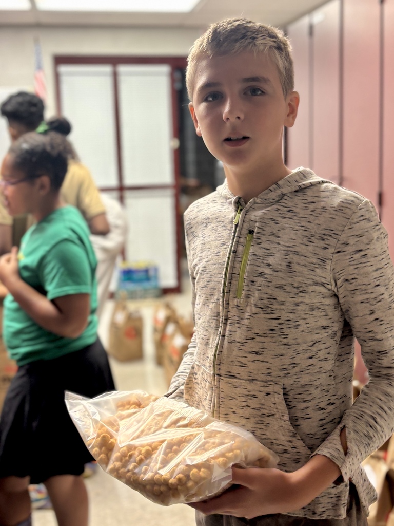 A student holds a bag of cereal.