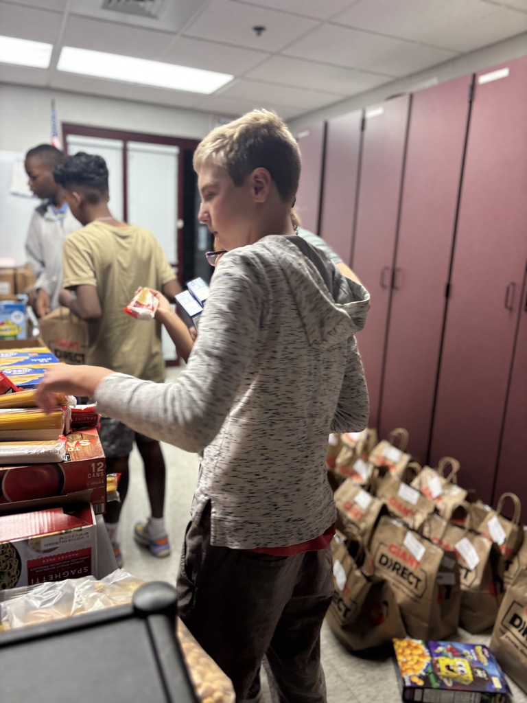 Students pack food bags.