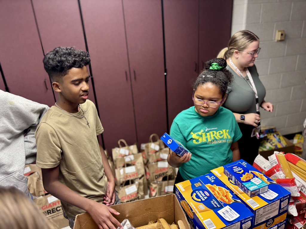 Students pack food bags.